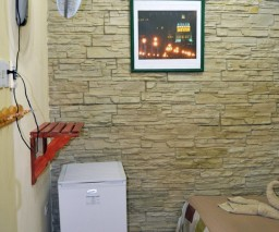 An image of a wall fan and bar fridge in Hostal Matos Galan Room 3 in Old Havana, Cuba