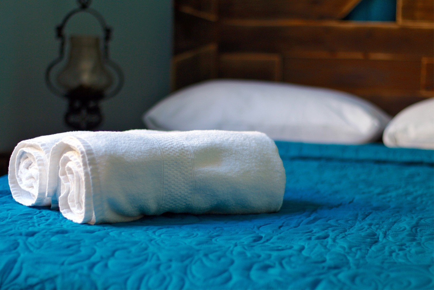 Clean white towels in a blue hotel room in Old Havana